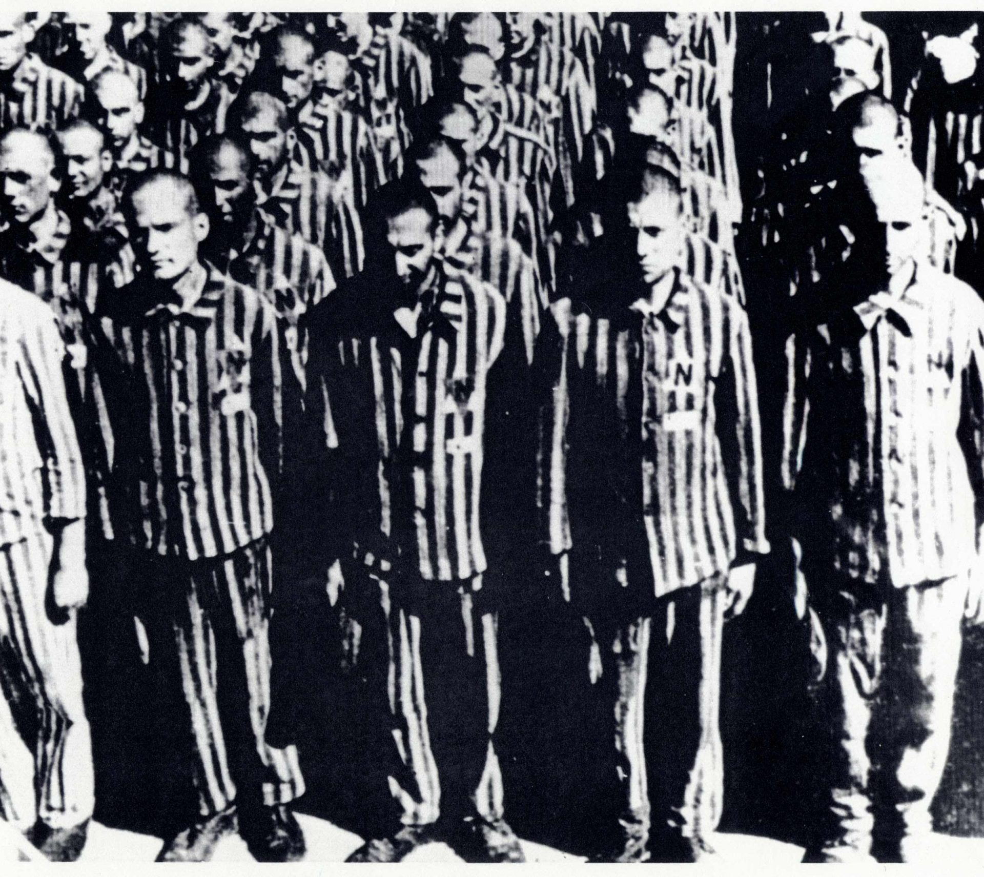 Dutch prisoners at the Buchenwald concentration camp (Germany), February 28 1941. This photo is an equally powerful illustration of the dehumanization of prisoners as an image of a mountain of corpses would be, while maintaining respect for the victims and avoiding shocking content : all the prisoners have shaved heads, are wearing the same uniform and are made to stand in line for hours on end. 