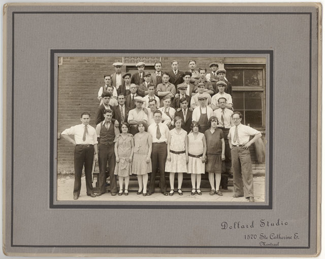 Photograph of Ideal Upholstering employees. Adolph Singer is the first of the front row from the right. 