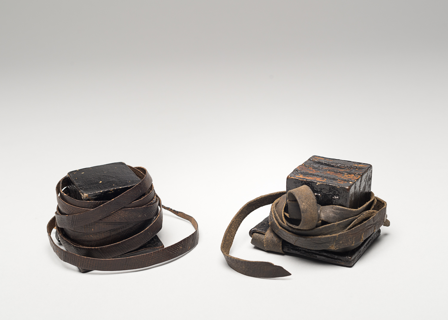Tefillin are religious objects composed of two black cubic boxes with leather straps. (Photo: Peter Berra)